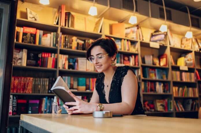 Woman reading books while relaxing in the cafe or a bookstore