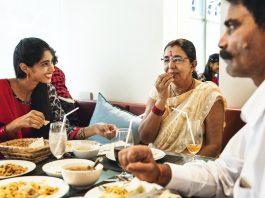 Happy Indian family having Indian food