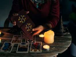 Pythoness woman shuffles tarot cards