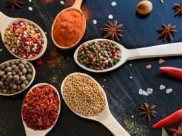 Spices and herbs on old kitchen table